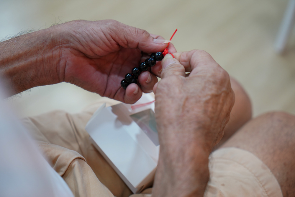 Bracelet-making was one of the activities which got many seniors excited during the Chinese New Year party. (Photo by Chan May Ching)